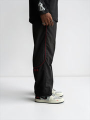 Premium straight-fit track pants for a clean, modern look. A3 Black with red line