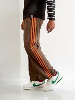 Premium straight-fit track pants for a clean, modern look. (brown with orange straps)