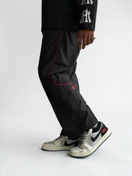 Premium straight-fit track pants for a clean, modern look. A3 Black with red line