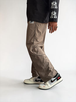 Premium straight-fit track pants for a clean, modern look. A3 Brown with black strap